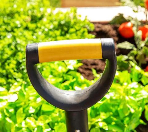 Compact 30 Inch Mini Shovel For Precision Digging with cushioned D-Grip handle in a garden setting