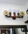 Three Lights Water Tube Wall Sconce With Retro Industrial Steampunk Style Antique Bronze Finish Red Valve Wheel Dual Roman Numeral Clocks