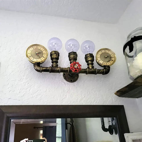 Three Lights Water Tube Wall Sconce With Retro Industrial Steampunk Style Antique Bronze Finish Red Valve Wheel Dual Roman Numeral Clocks