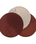 Close-up of 3 sandpaper discs showcasing 20 Pcs 3 Inch 75 Mm Red Sandpaper Discs With Hook Loop Fastener for wood polishing.
