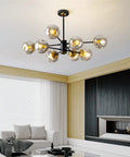 8-Light Black And Gold Sputnik Light Fixture Modern Chandelier With Smoked Glass Globes in living room setting