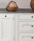 Set of 10 Rustic 1-1/2 Inch Black Iron Cabinet Knobs, installed on white kitchen cabinets, showing vintage farmhouse style