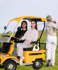 Kickin Up Dust 4 Wheel Electric Golf Cart Sweet Comfort Mobility Scooter for Mature Riders with two women sitting in bright yellow cart.