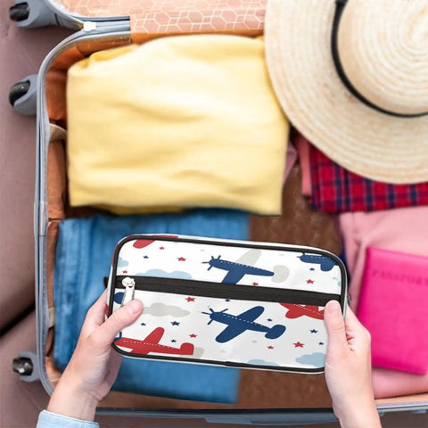 Person packing an Adorable Airplane Travel Makeup Bag For Women And Men in a suitcase, showcasing airplane design.