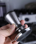 Top-Tier Coffee Tamping Station With Built-In Espresso Knock Box And Portafilter Holder Keeps Your Bar Setup Crisp Fits 58mm Portafilters, showing a sleek metal tamper.