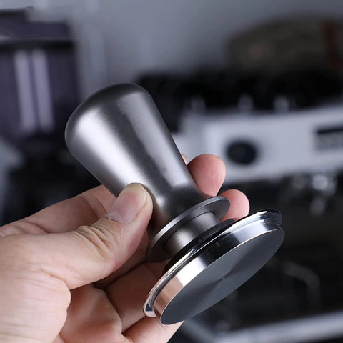 Slick Espresso Tamping Station And Knock Box Fits 58mm Portafilters Like A Glove While Catching Grounds Quickly, showing a steel tamper.
