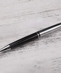 Rotary 0.5mm Ballpoint Pen Set With Leather Grip, Metal Body And Smooth Gel Ink, placed on wooden surface