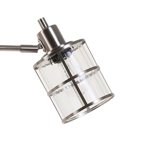 Close-up of ribbed glass shade on modern three light floor lamp with reading light, cool brushed nickel finish.