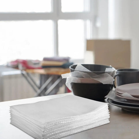 Thick EPE Foam Pouches For Packing And Shipping With Shock Absorbing Protection on a table near stacked dishes.