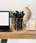 Two Piece Square Post Note Holder And Circle Pen Holder Metal Desk Organizer Set in rose gold on a desk with a globe and laptop