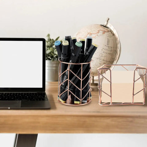 Two Piece Square Post Note Holder And Circle Pen Holder Metal Desk Organizer Set in rose gold on a desk with a globe and laptop