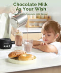 No Sweat Electric Milk Steamer And Frother Game Changer For Coffee Lovers Generating Top Shelf Barista Level Creamy Foam pouring chocolate milk into a glass next to a child and bagels.