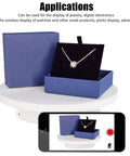 Heavy Duty Rotating Display Stand With White Plug In Remote Motorized Electric Turntable For 360 Degree Photography And Video Shoots showcasing jewelry in blue box.