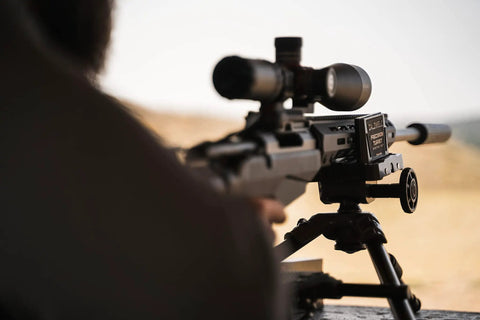 Rifle mounted on Beefed Up Ambidextrous Turret Rest With Adjustable Swivel under shooting conditions, emphasizing stability.