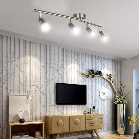 Sleek Modern LED 4-Light Track Lighting Kit With Flush Mount for wall or ceiling illuminating a living room with adjustable spotlights.