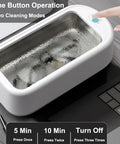 All In One Ultrasonic Glasses And Jewelry Cleaner 640ML 48KHz Powerful Sonic Cleaning Machine in operation near a laptop