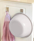 Rock Solid Stainless Steel Bathroom Hook With Tight Suction Mount For Hanging Towels And Scrub Brushes Heavy Duty Wall Organizer securing a purple towel and bowl.