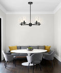 Dining room with Bold Black Five Light Adjustable Pendant Chandelier With Glass Shades, Model XB-C1240-5-MB, over a table.