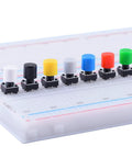 84 Pcs Momentary Tactile Push Button Switch Kit 6x6x8mm With 7 Color Button Caps on a breadboard setup