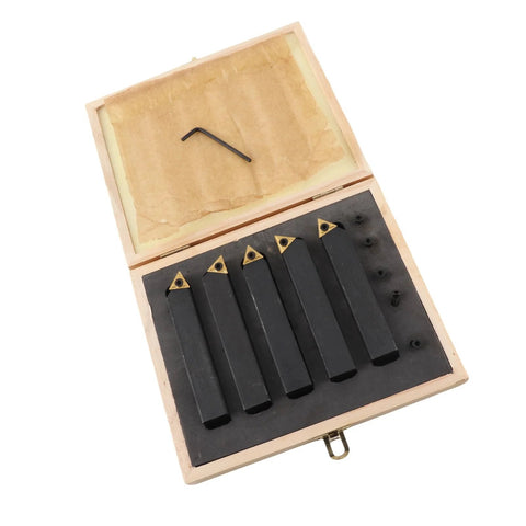 Five-piece carbide turning tool set in an open wooden box with indexable cutters and hex key