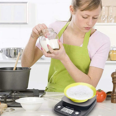 Person using Pro 22Lb Digital Kitchen Scale for Meal Prep And Weight Loss, Reads Grams Ounces And ML with Tare, 1G And 0.1Oz Precision.