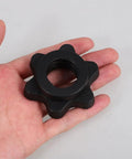 Hand holding a single screw collar from 8 Pack Barbell Screw Collars Nonslip Weight Lifting Clips for Dumbbells and Bars Durable Plastic Construction