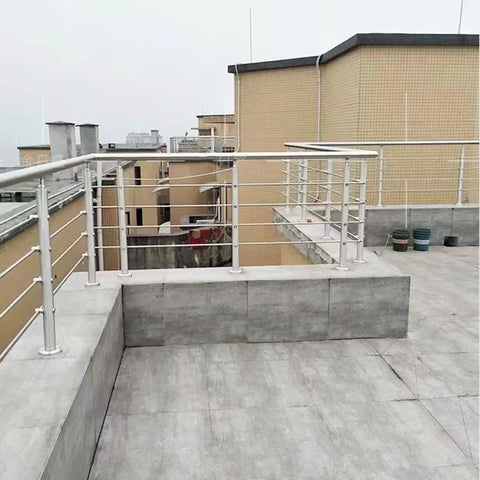 Heavy Duty 304 Stainless Steel Cable Railing Posts With Kickass Adjustable Angle Hardware For Rock Solid Deck Stair Safety And Weatherproof Outdoor Balcony Fencing on a rooftop terrace.