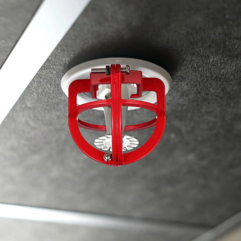 Knockout Pro Grade Heavy Duty Fire Sprinkler Head Guard Cover Protector Cage For Ceiling Impact Defense Hit Proof Metal Shell installed on ceiling.