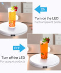 Tuanse 10 Inch Electric Motorized Rotating Turntable Cup Display Stand With Led Light, 360 Degree Product Showcase For Shop Jewelry Photography Video, White, 44 Lb Centric Loading Capacity with glass drink.