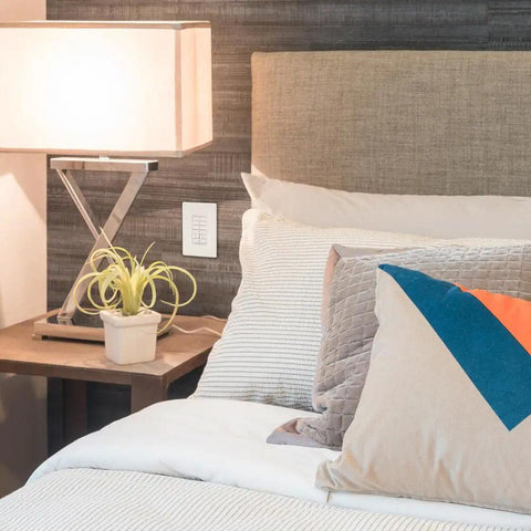 Bedroom with lamp and Smart Battery-Powered Multi-Room Scene Keypad For Home Lighting on wall, white, Bluetooth enabled