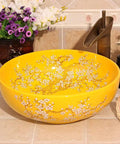 Top Tier Yellow Floral Ceramic Vessel Sink For Bathroom Countertop Featuring Handmade Artistry Slick Craftsmanship No Fuss Install With Center Drain And Fresh Vibes To Level Up Your Bathroom. Round ceramic vessel sink with bright yellow finish and floral design.