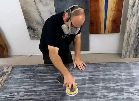 Person using a sander with Sanding Disc Variety Pack For Stone, Tile, And Countertops, 9 Round Abralon And Abranet Polishing Discs With Grits 220 To 4000