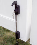Lockable Security Drop Bolt For Wood And Vinyl Gates 24 Inch Length Prevents Dropping And Dragging With Retention Grooves Key Lockable Gate Bolt For Driveways And Commercial Use Industrial Strength Metal Replacement installed on a white gate.