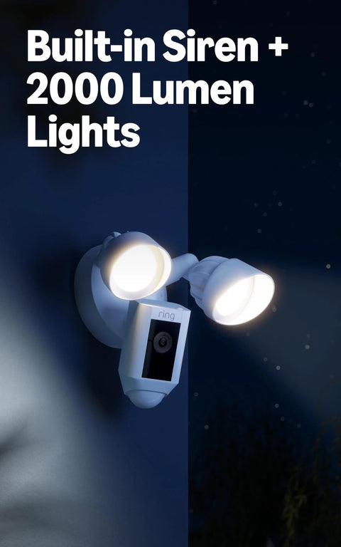 Front view of Ring Floodlight Cam Wired Plus outdoor security camera with dual white floodlights mounted on wall.