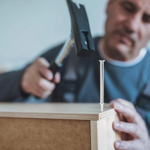 Built Tough Double Head Skirting Nails 200 Piece Pack seamless coil fasteners being hammered into wood for trim installation.