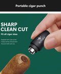 Hand holding portable cigar punch from Five Piece Cigar Cutter Set With Stainless Steel Guillotine, V Cut, Punch, Cigar Stand, Leather Case And Gift Box