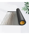 Heavy Duty Black Asphalt Crack Repair Tape, Waterproof Self Adhesive Roll, rolled on a flat surface, showing aluminum foil side.