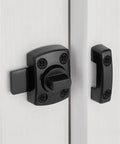Gate Latch Slide Bolt Lock Rotating Hasp Latches Double Sided Locks in black, mounted on a white door with screws.