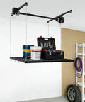 Hardcore Adjustable Overhead Garage Storage Rack With 300 Pound Capacity Rustproof Carbon Steel Ceiling Mount Hanger holding tools and paint cans.