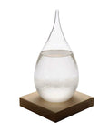 Front view of Storm Glass Weather Predictor with teardrop crystal bottle on wood base, ideal for home or office decor.