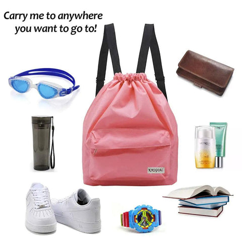 Pink Dry Wet Separated Swim Bag With Drawstring Backpack surrounded by goggles, water bottle, shoes, wallet, and skincare items.