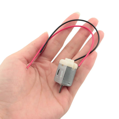 Person holding a Six Pack 130 Size Mini DC Motor 3V with 15 cm copper wire for small DIY projects like electric shavers and toys.