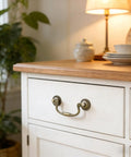 4-Piece Antique Bronze Drop Bail Drawer Pulls With Screws, used on a white cabinet in a cozy room setting.