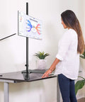 Woman using Tall Floor Monitor Mount With Extra Long 47 Inch Pole For Free Standing Desk Setup Adjustable Single Arm Fits 13 To 27 Inch Screens Up To 22 Lbs Easy Height Tilt And Depth Adjust To Cut Eye Strain at a desk