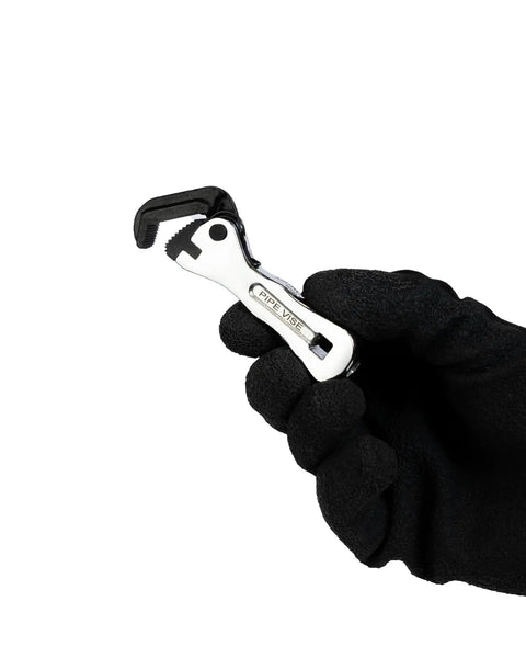 Compact Self Adjusting Pipe Vise With Sweet Ratchet Action and Nifty Contoured Grip For Tight Spots held in gloved hand, showcasing chrome finish.