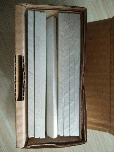 Open box of Soapstone Pencils 27 Pack for Welding and Textile Marking, Flat White Stone Refills visible inside.