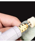 Hand using a rotary tool with Built Tough Wool Buffing Wheels And Grinding Heads With Point Mandrel Kit For Rotary Tools.