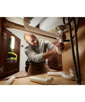 One Plus Hybrid LED Project Light With 900 Lumens illuminating workspace under the sink during plumbing work