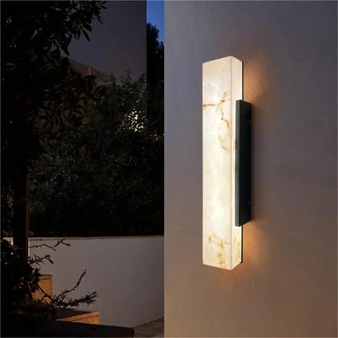 Modern Linear Wall Sconce Imitated Marble LED Wall Light,Warmth mounted on a wall with warm light illuminating a textured surface.