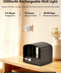 Go-To Remote Controlled Motion Sensor Wall Light charging on table with USB cable in black, 5000mAh battery visible